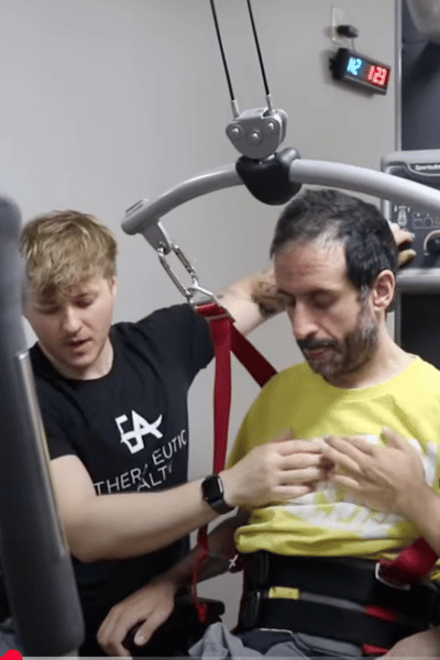 Rida receiving physical therapy and personal training to support spinal cord injury recovery
